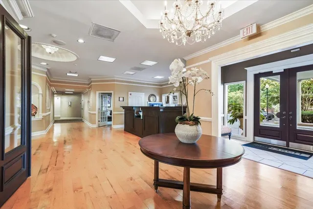 a lobby with furniture and chandelier
