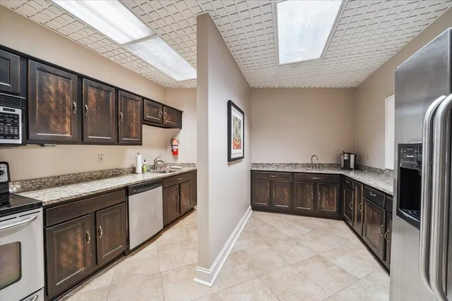 a kitchen with stainless steel appliances granite countertop a stove and a refrigerator