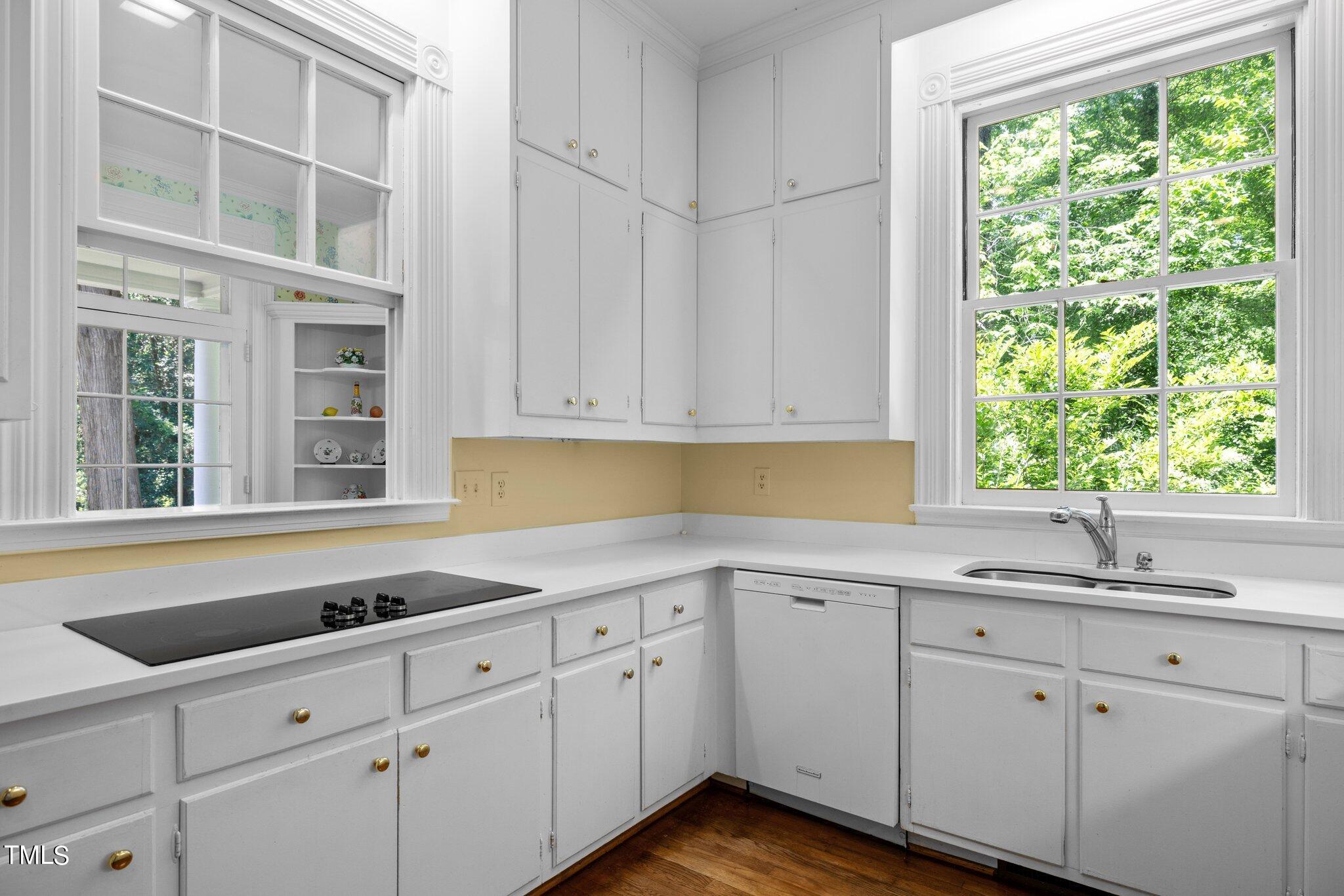 3116 Cornwall Road Durham, NC 27707 - Photo 17 of 85 a kitchen with stainless steel appliances white cabinets and a sink