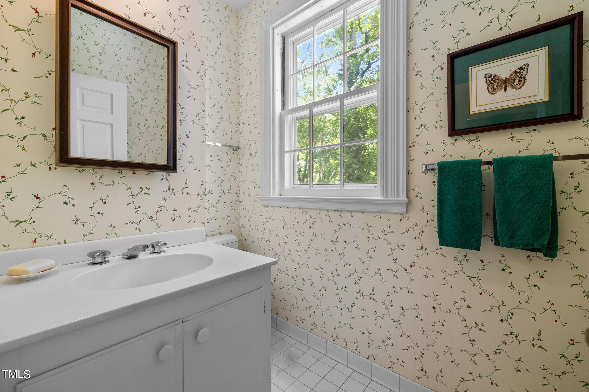 3116 Cornwall Road Durham, NC 27707 - Photo 20 of 85 a bathroom with a sink and a mirror