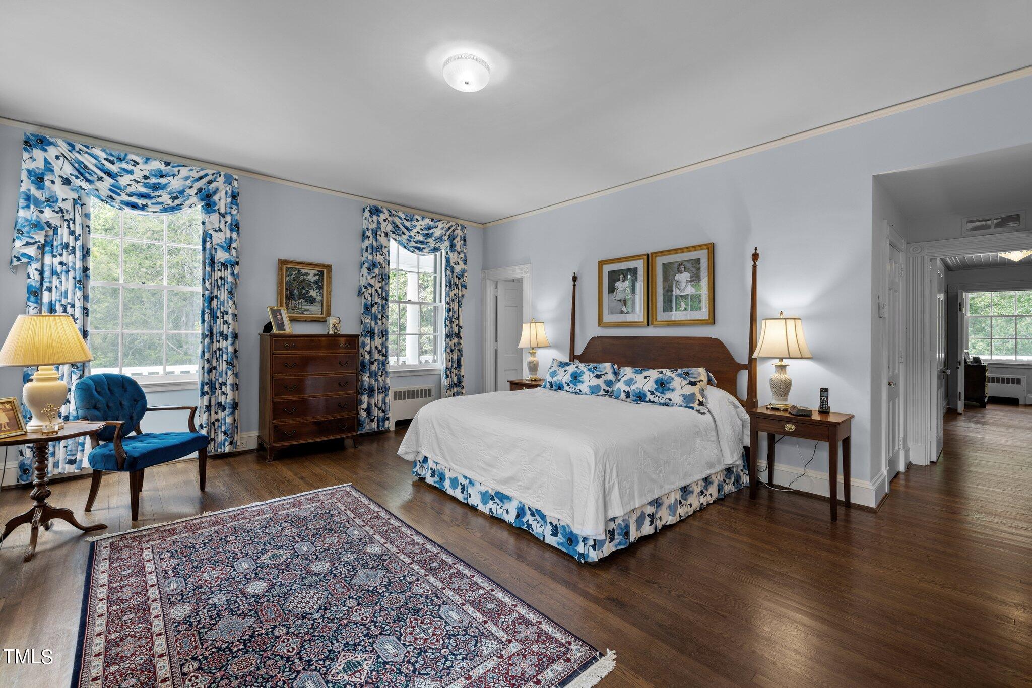 3116 Cornwall Road Durham, NC 27707 - Photo 35 of 85 a bedroom with a bed a chair and a potted plant on the dresser