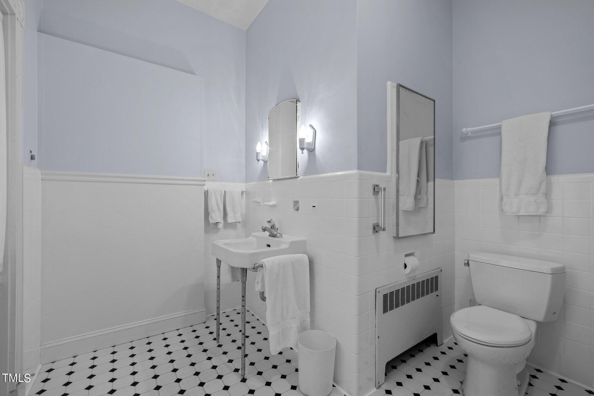 3116 Cornwall Road Durham, NC 27707 - Photo 38 of 85 a bathroom with a sink toilet and shower