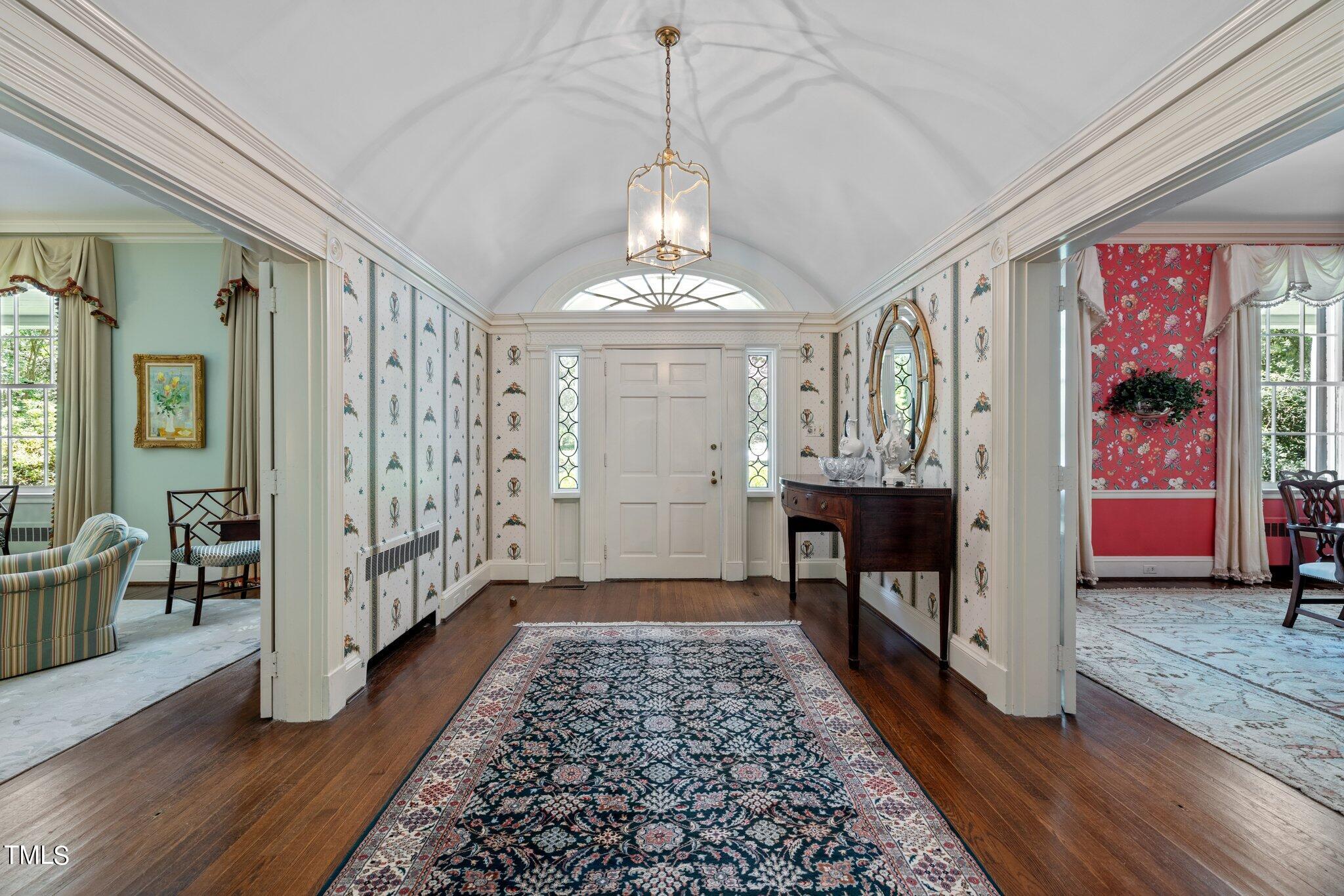 3116 Cornwall Road Durham, NC 27707 - Photo 6 of 85 a view of a hallway with wooden floor windows and livingroom with chandelier