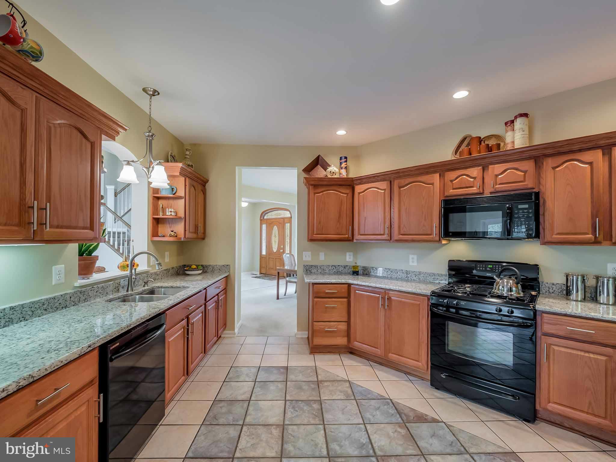 13110 Soundings Road Lusby, MD 20657 - Photo 11 of 30 a kitchen with stainless steel appliances granite countertop a stove sink and cabinets