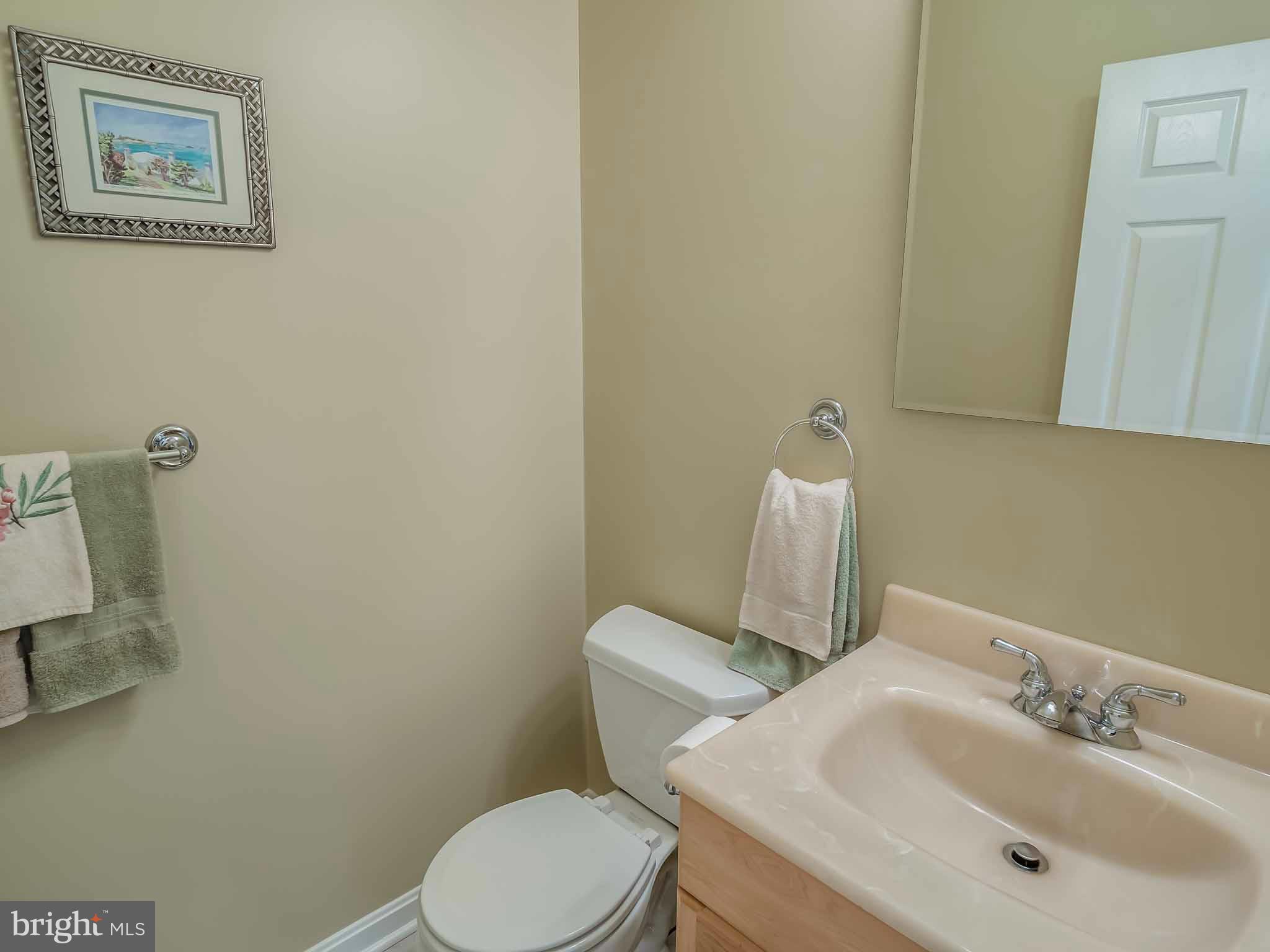 13110 Soundings Road Lusby, MD 20657 - Photo 15 of 30 a bathroom with a toilet sink and mirror