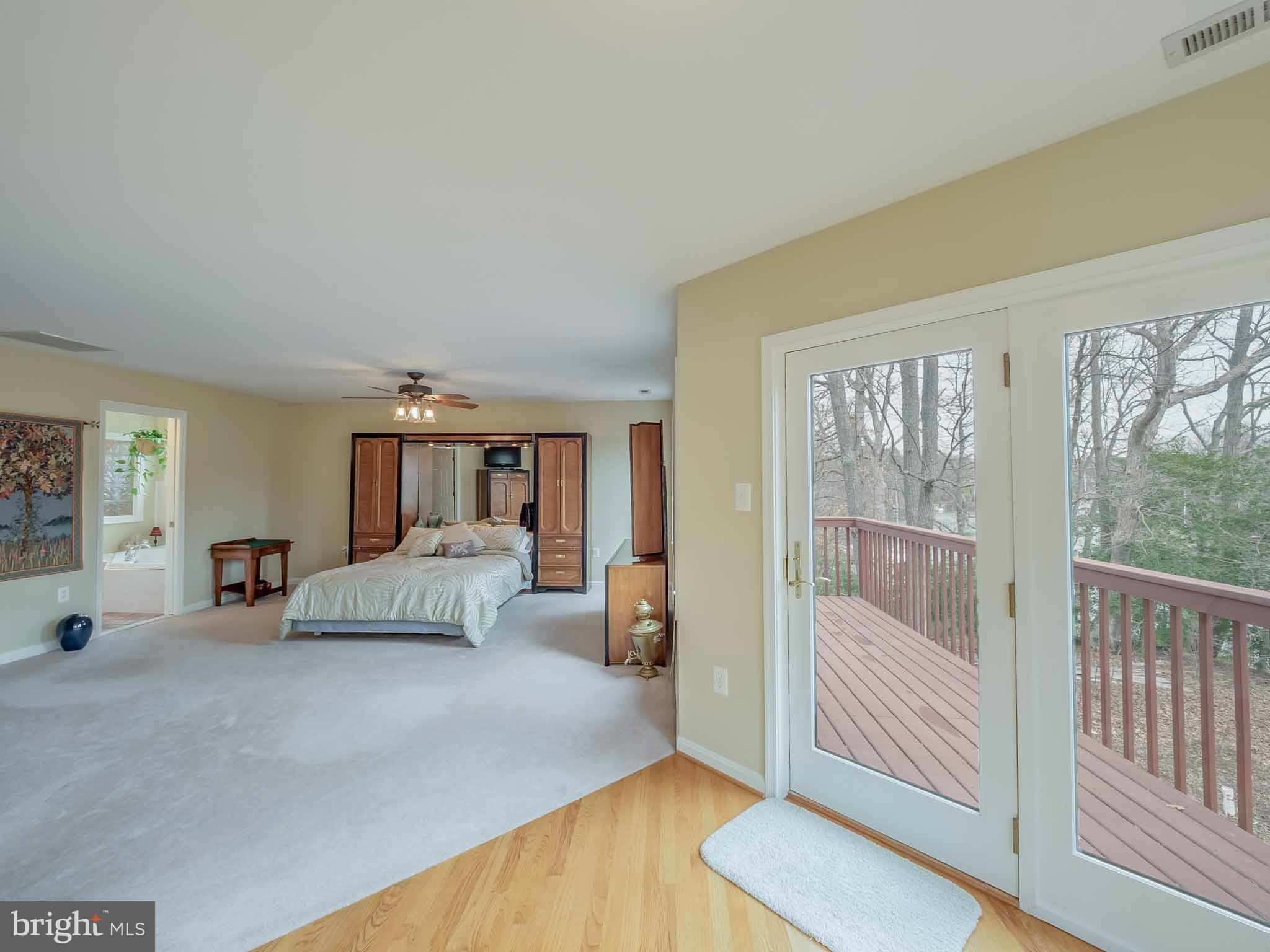 13110 Soundings Road Lusby, MD 20657 - Photo 23 of 30 a bedroom with a large bed and a large window