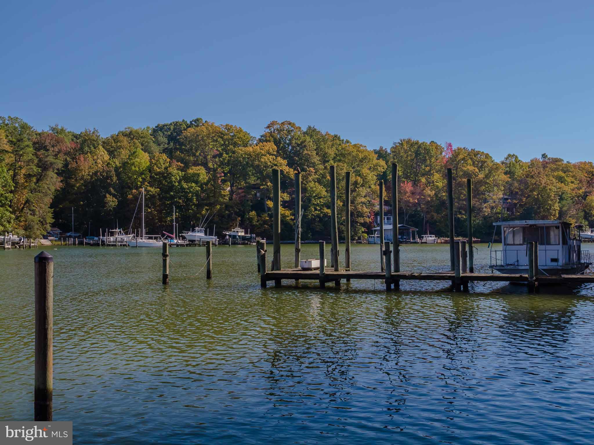 13110 Soundings Road Lusby, MD 20657 - Photo 30 of 30 a view of a lake with a building in the background