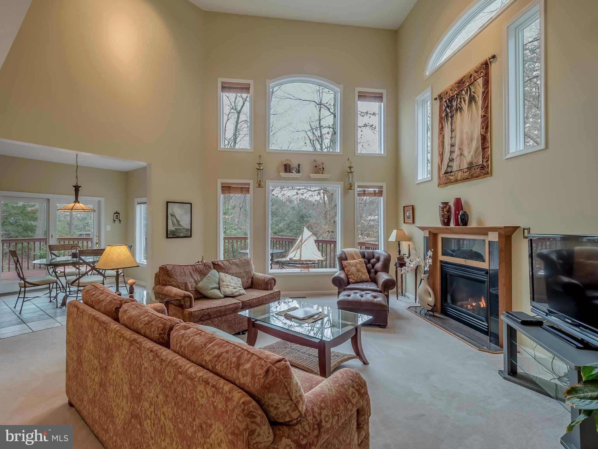13110 Soundings Road Lusby, MD 20657 - Photo 7 of 30 a living room with furniture fireplace and a flat screen tv