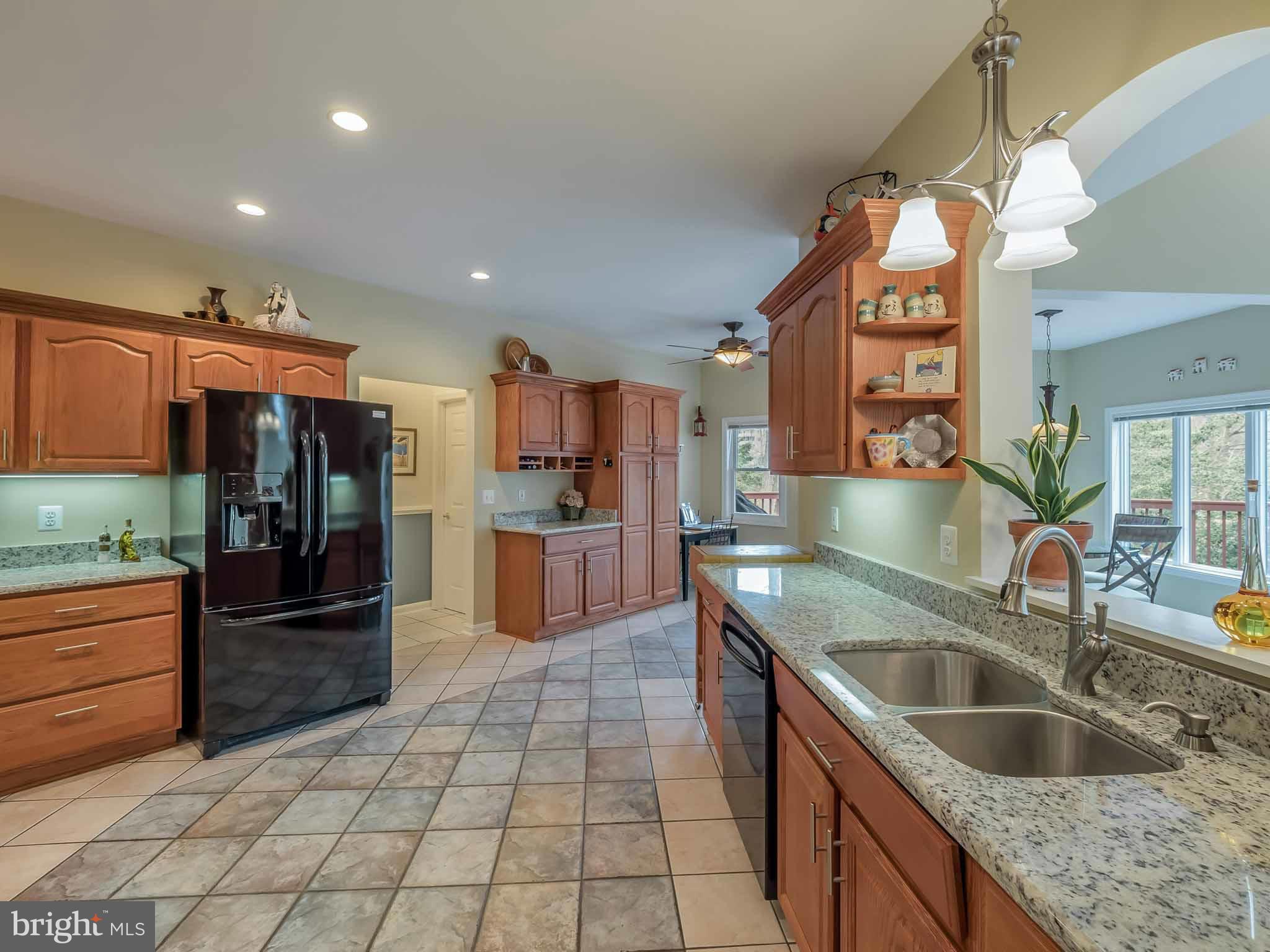13110 Soundings Road Lusby, MD 20657 - Photo 10 of 30 a kitchen with stainless steel appliances granite countertop a sink and a refrigerator