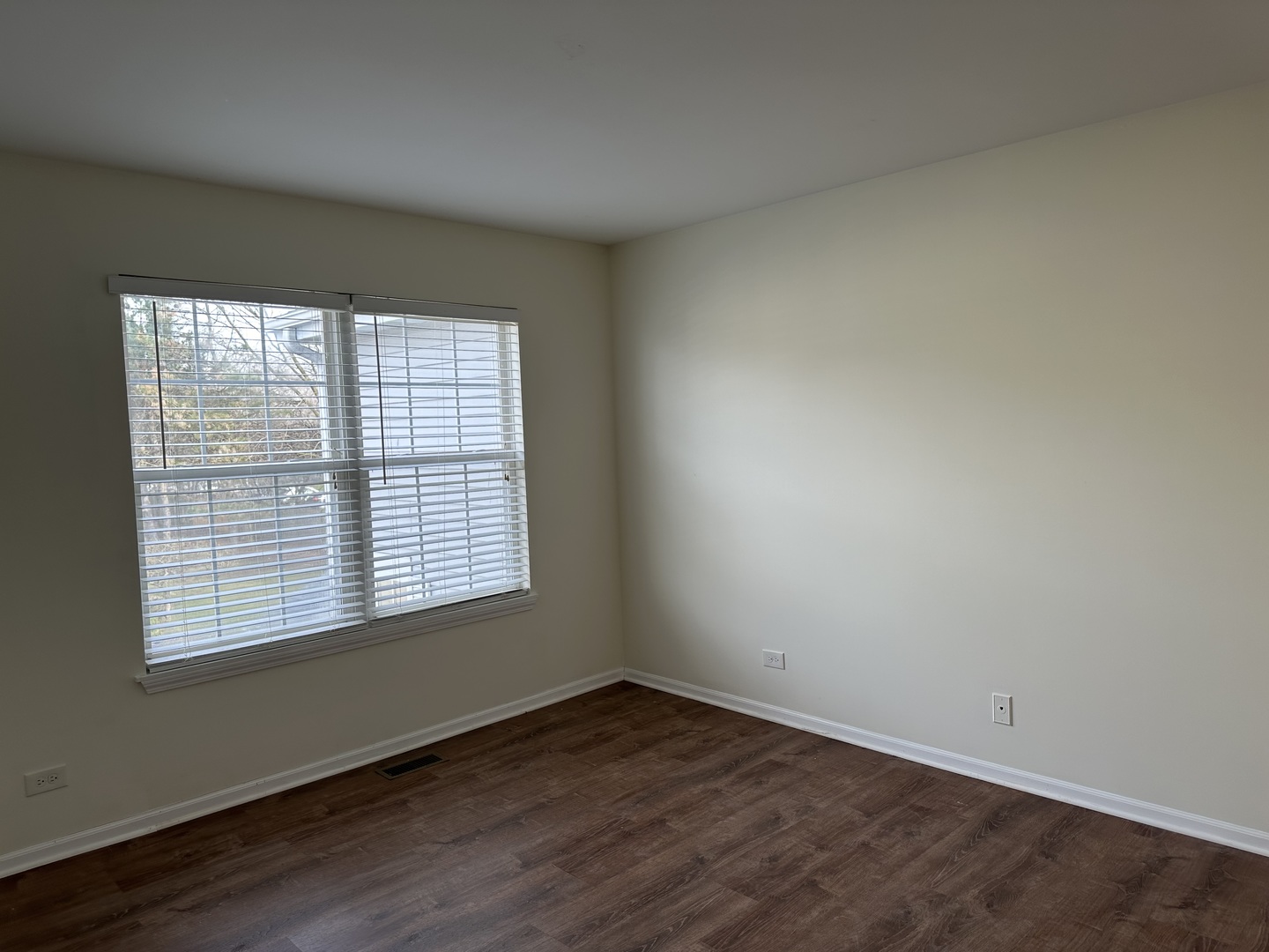 1361 Orleans Drive Mundelein, IL 60060 - Photo 10 of 13 an empty room with wooden floor and windows