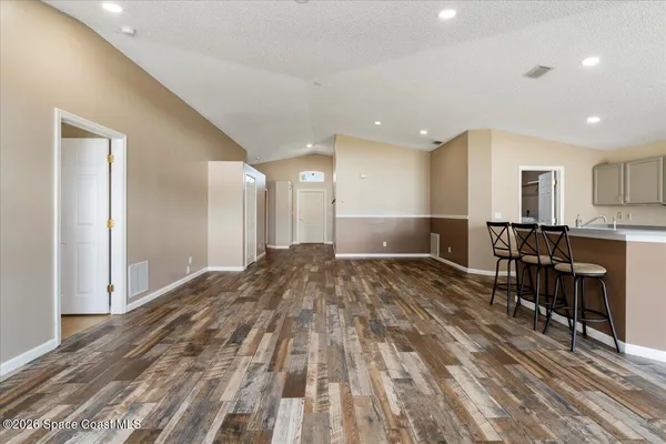 a view of a hallway with wooden floor