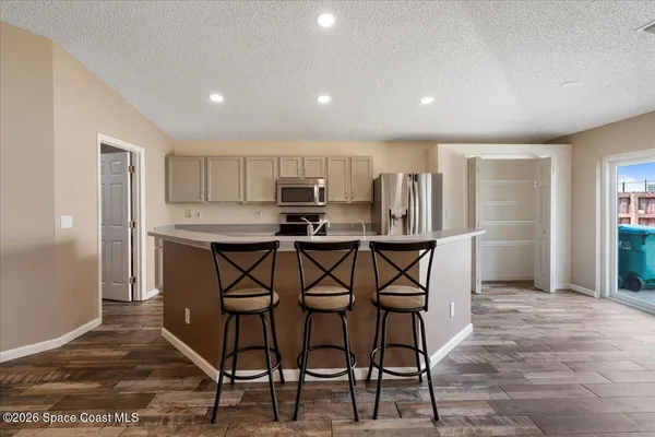 an empty room with closet and windows