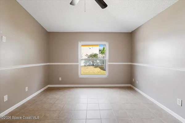 a view of room with window and ceiling fan