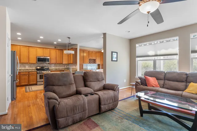 a living room with furniture and kitchen view