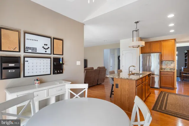 a living room with furniture a flat screen tv and large windows