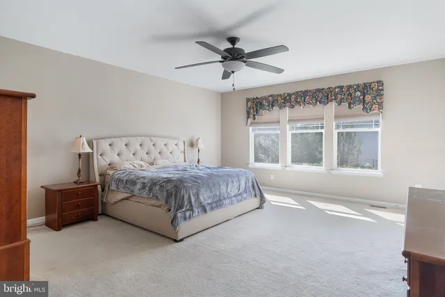 a bedroom with a large bed and a large window