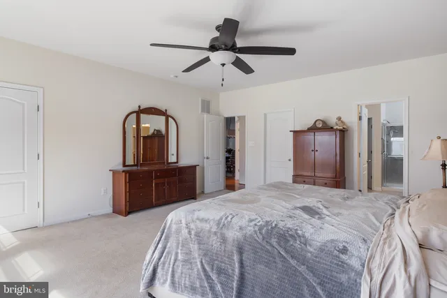 a bedroom with a bed and a dresser