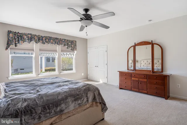 a bedroom with a large bed and a dresser