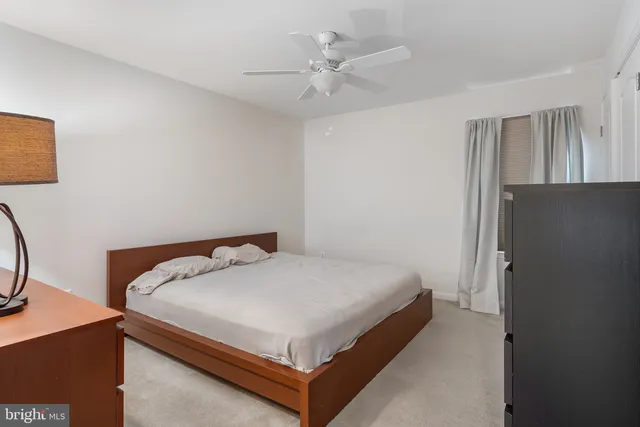 a bedroom with a bed and a table