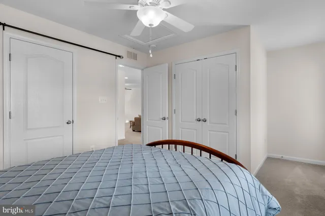 a bedroom with two beds and window