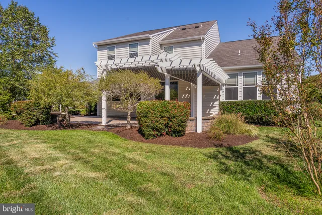 a view of a backyard with plants and a patio