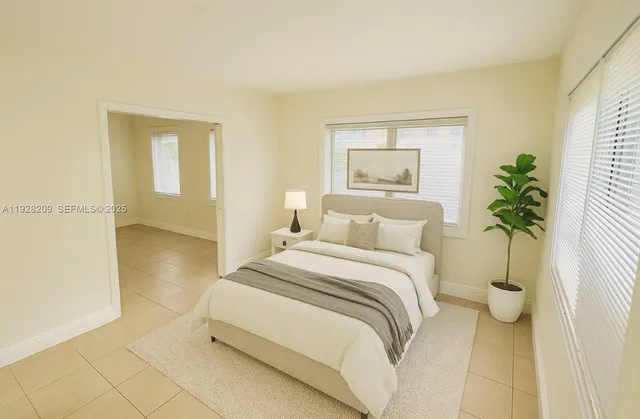 a bedroom with a bed and a potted plant