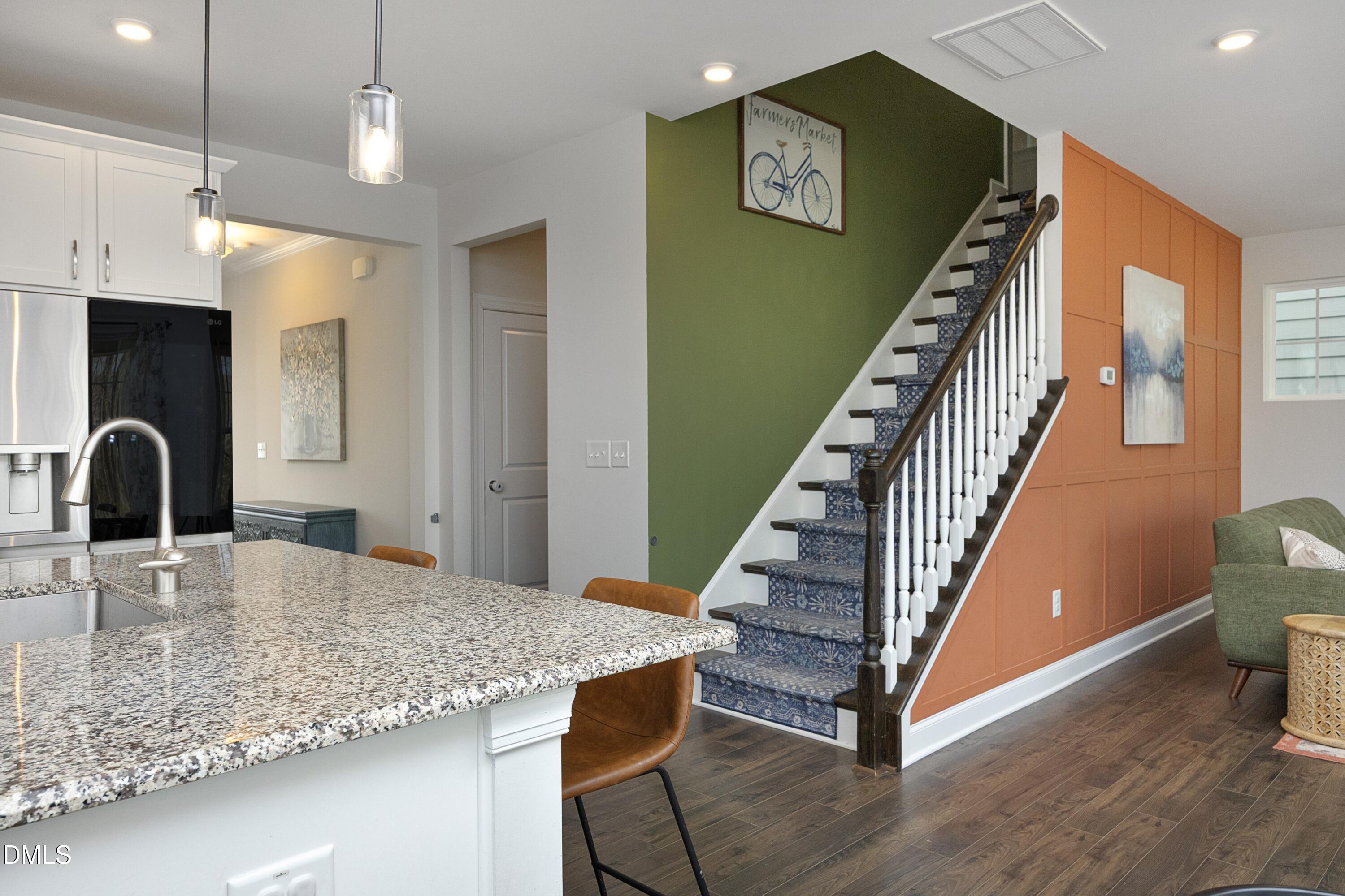 500 Ressler Street Holly Springs, NC 27540 - Photo 10 of 37 a kitchen with kitchen island a counter top space a sink stainless steel appliances and cabinets