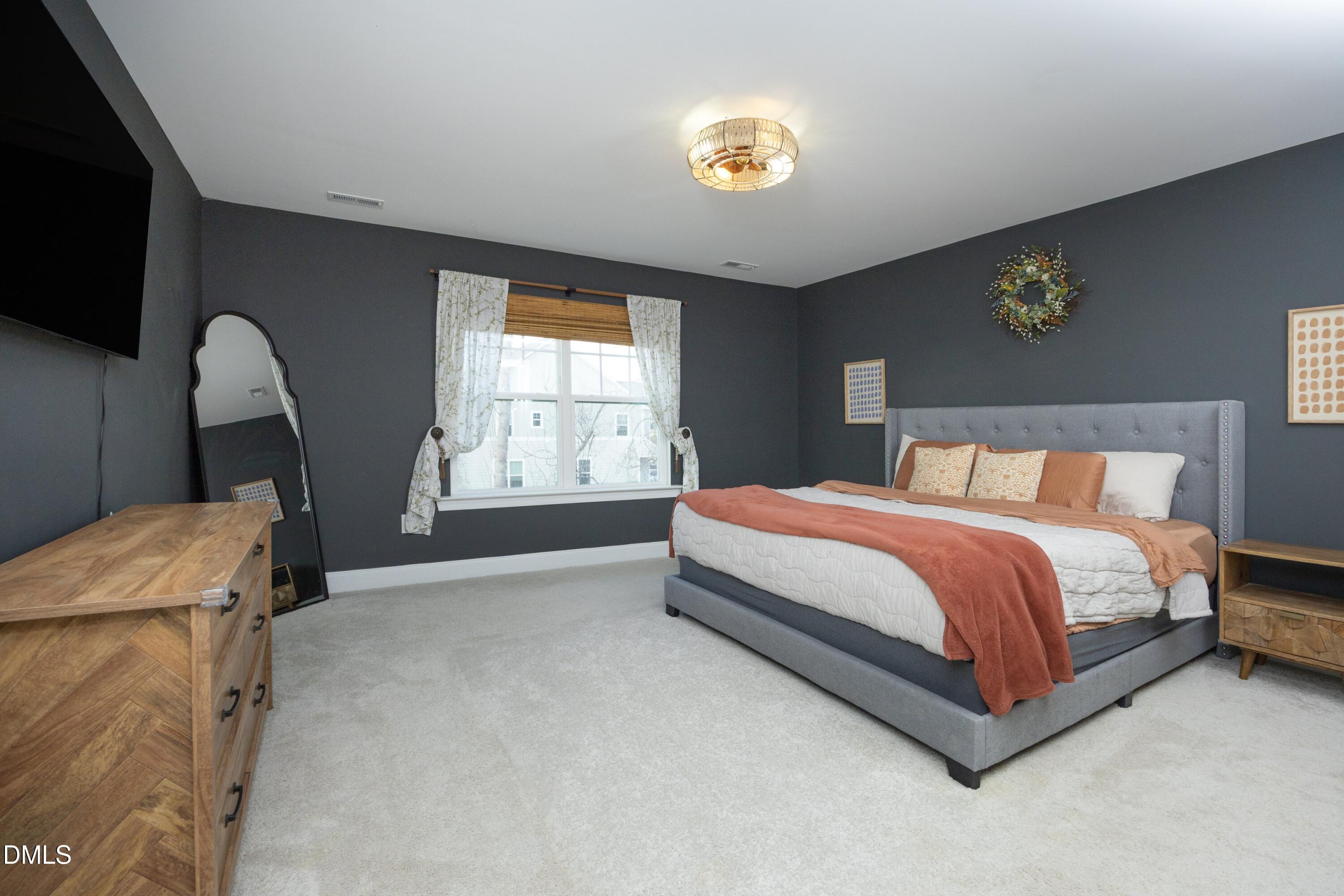 500 Ressler Street Holly Springs, NC 27540 - Photo 13 of 37 a bed sitting in a room next to a window