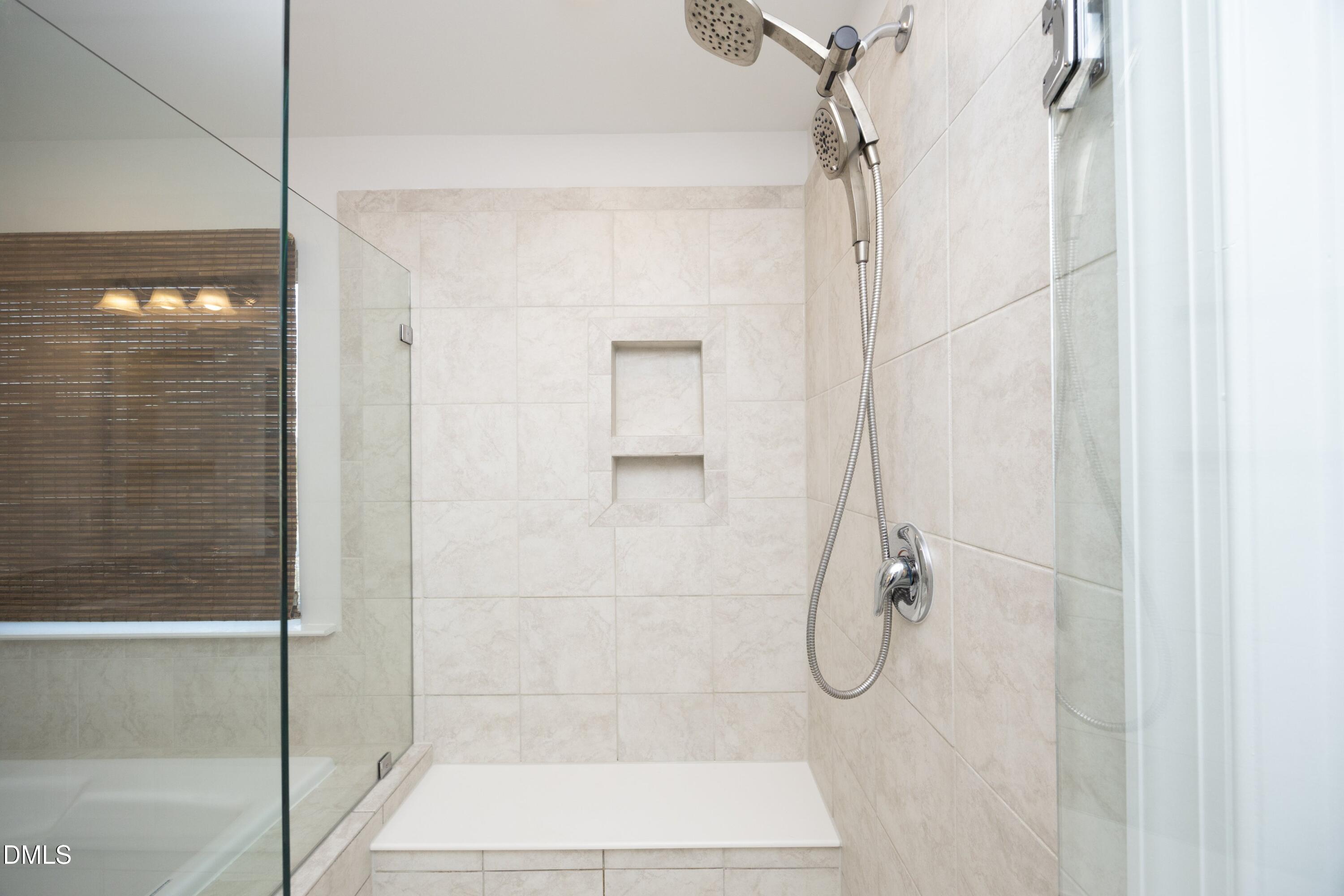 500 Ressler Street Holly Springs, NC 27540 - Photo 15 of 37 a bathroom with a glass shower door