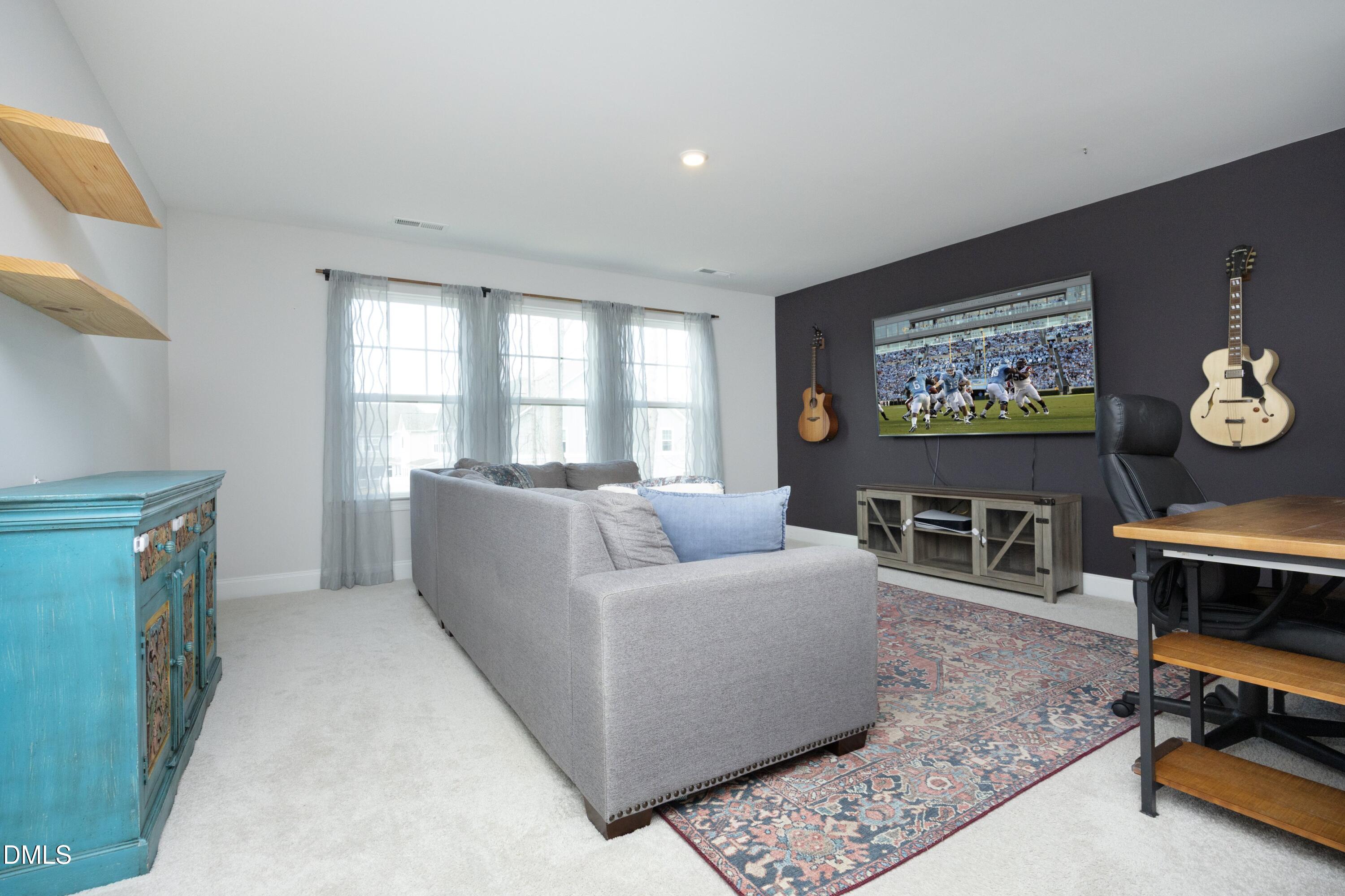 500 Ressler Street Holly Springs, NC 27540 - Photo 17 of 37 a living room with furniture kitchen view and a window