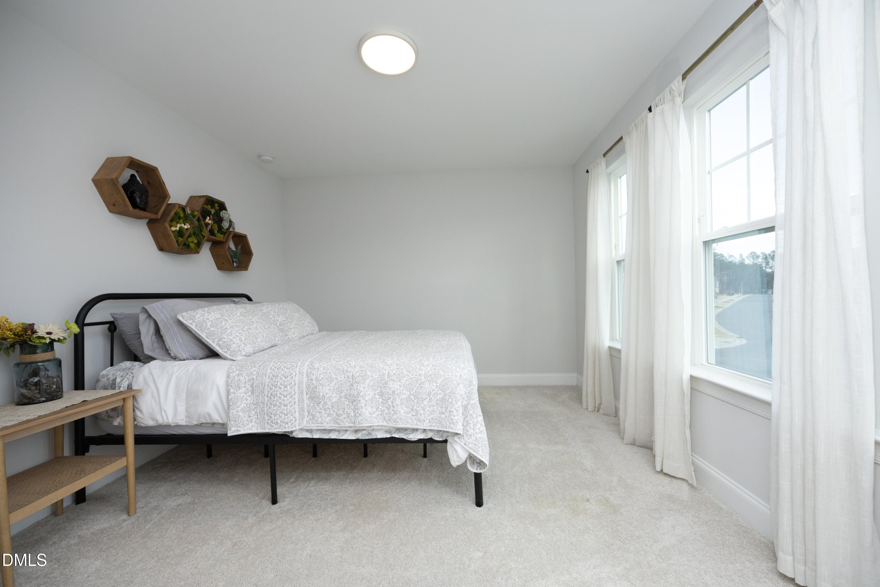 500 Ressler Street Holly Springs, NC 27540 - Photo 19 of 37 a bedroom with a bed and window