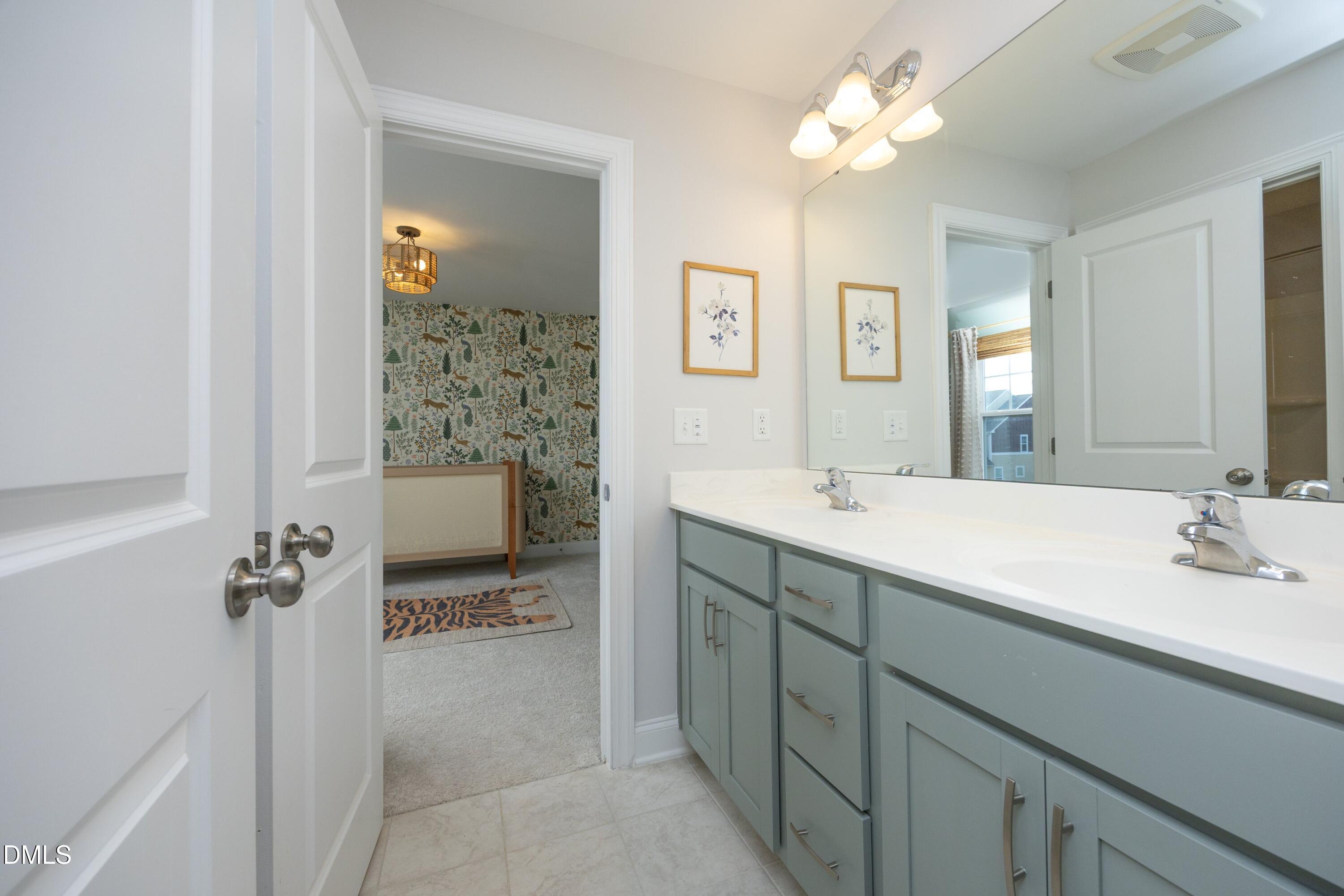 500 Ressler Street Holly Springs, NC 27540 - Photo 20 of 37 a en suite bathroom with a double vanity sink a mirror and a shower