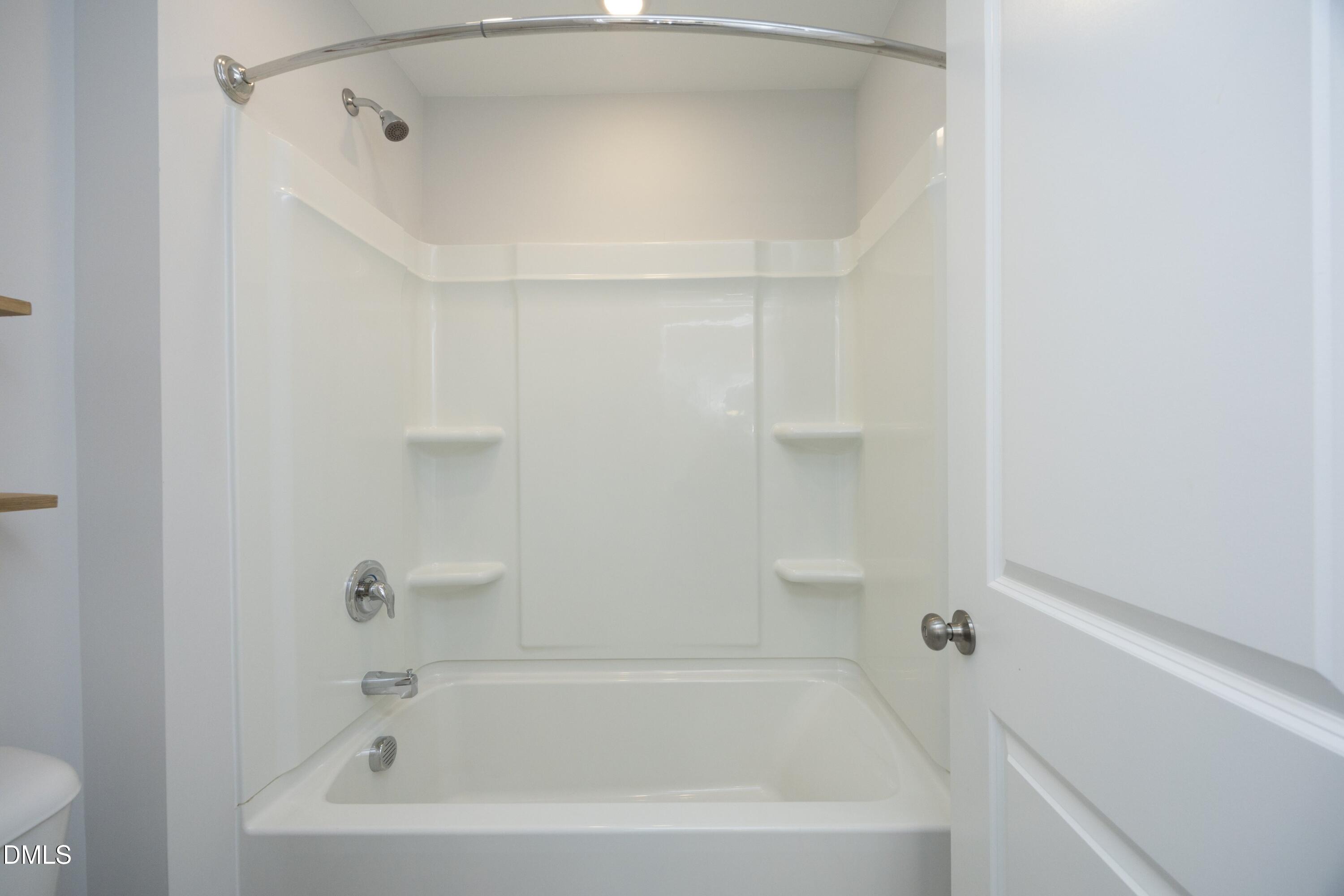500 Ressler Street Holly Springs, NC 27540 - Photo 21 of 37 a white bath tub sitting next to a white sink and vanity