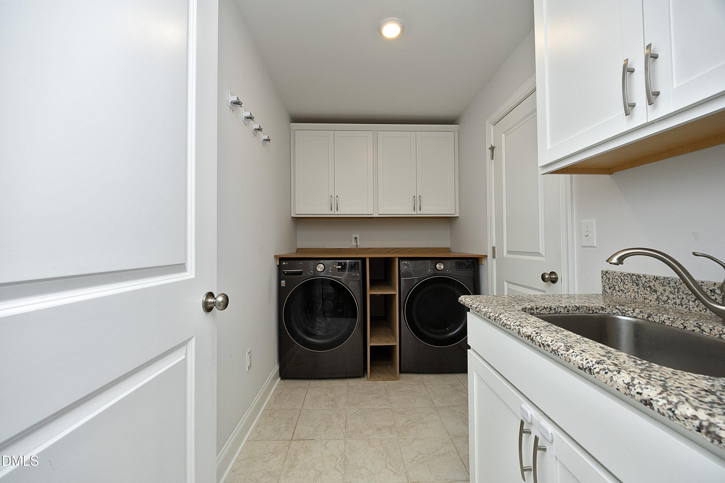 500 Ressler Street Holly Springs, NC 27540 - Photo 25 of 37 a kitchen with a stove a sink and a refrigerator