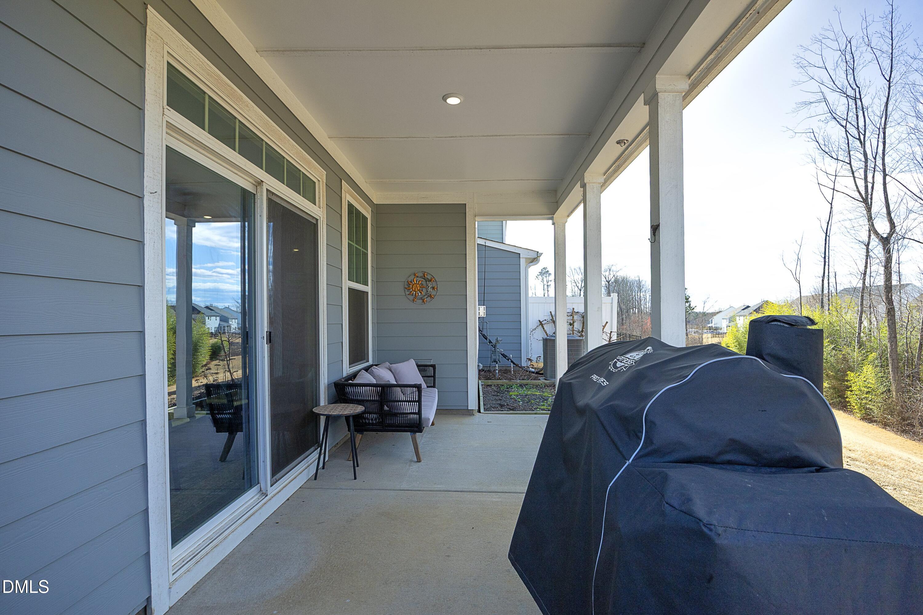 500 Ressler Street Holly Springs, NC 27540 - Photo 27 of 37 a living room with furniture and a floor to ceiling window