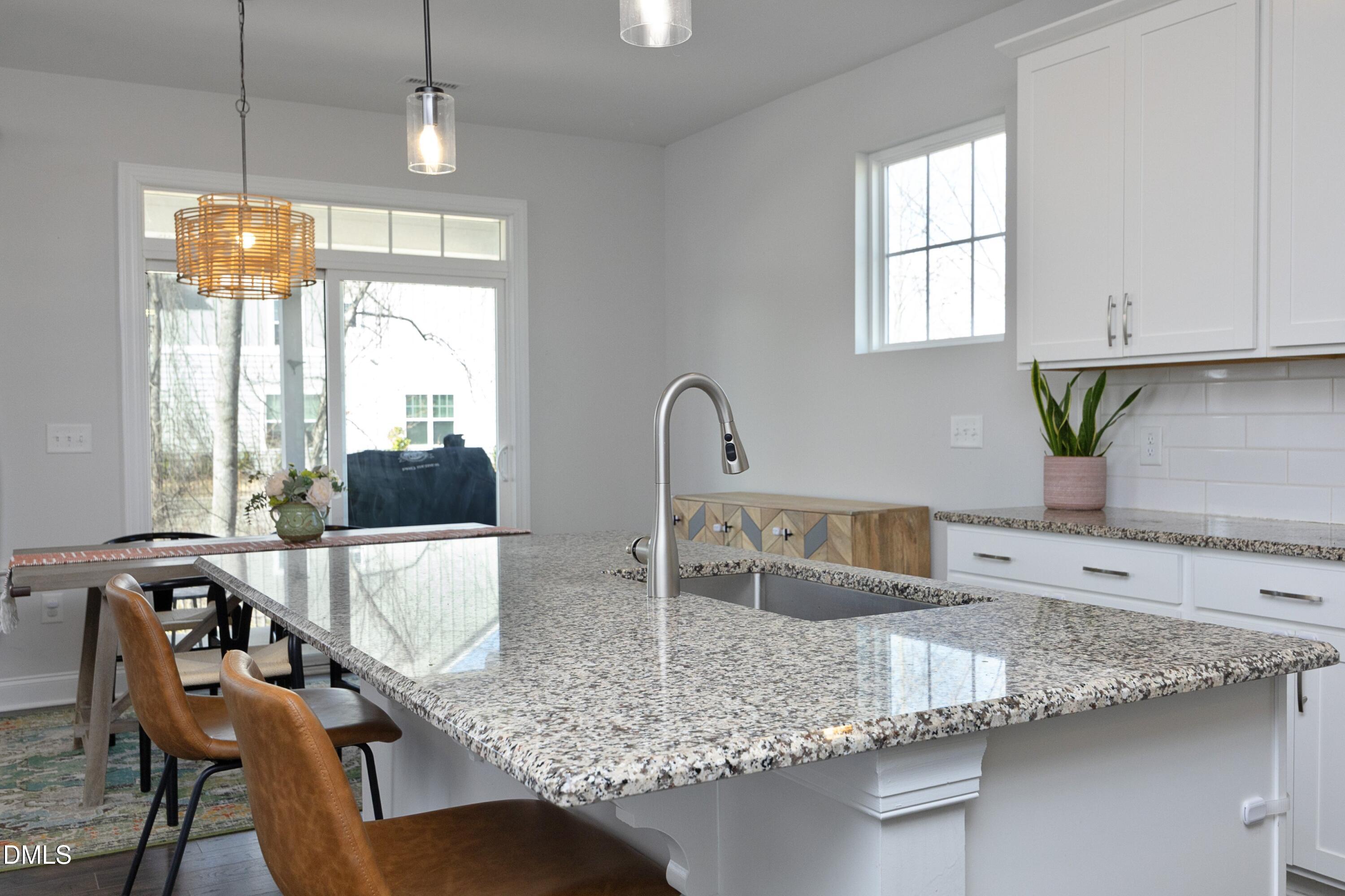 500 Ressler Street Holly Springs, NC 27540 - Photo 5 of 37 a kitchen with granite countertop a sink a counter top space and cabinets
