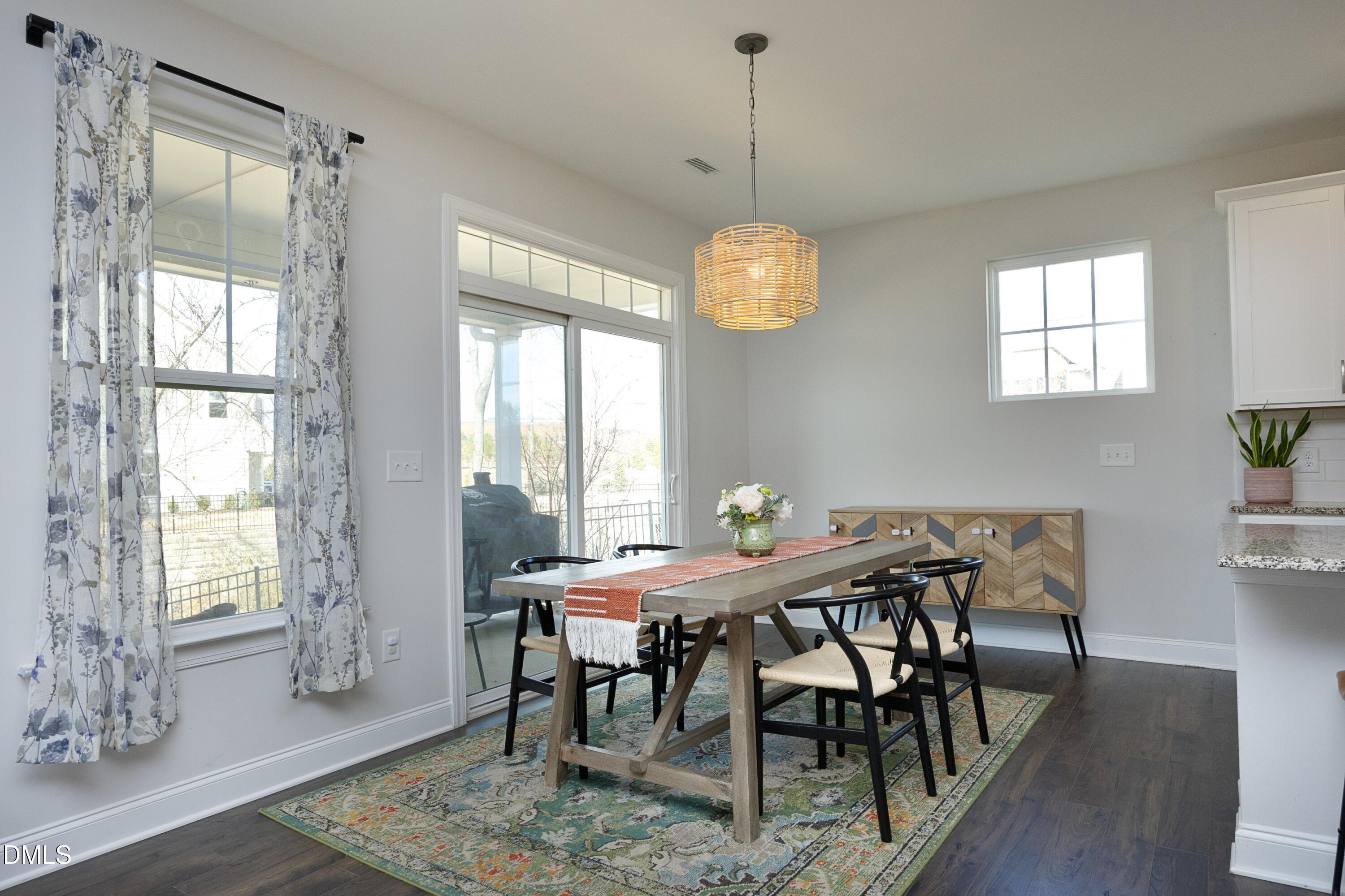 500 Ressler Street Holly Springs, NC 27540 - Photo 7 of 37 a view of a dining room with furniture window and wooden floor