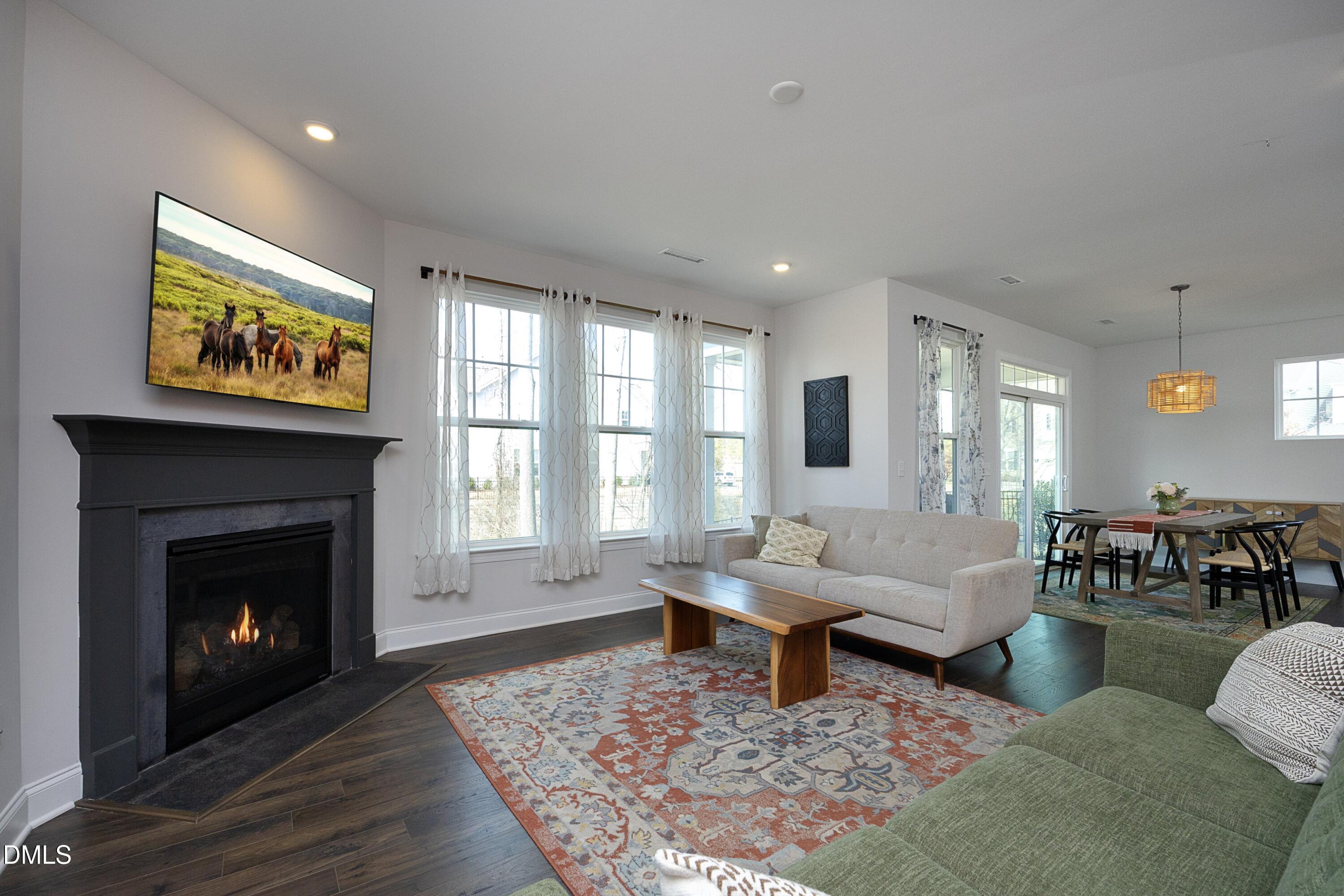 500 Ressler Street Holly Springs, NC 27540 - Photo 8 of 37 a living room with furniture or couch and a fireplace