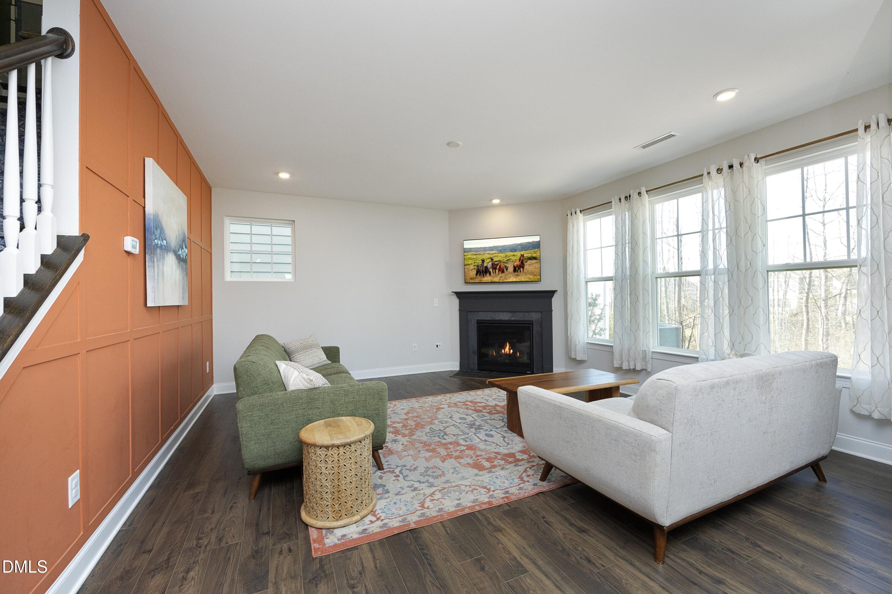 500 Ressler Street Holly Springs, NC 27540 - Photo 9 of 37 a living room with furniture and a fireplace