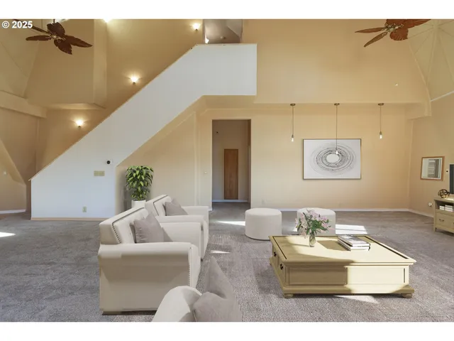 a living room with furniture and a potted plant