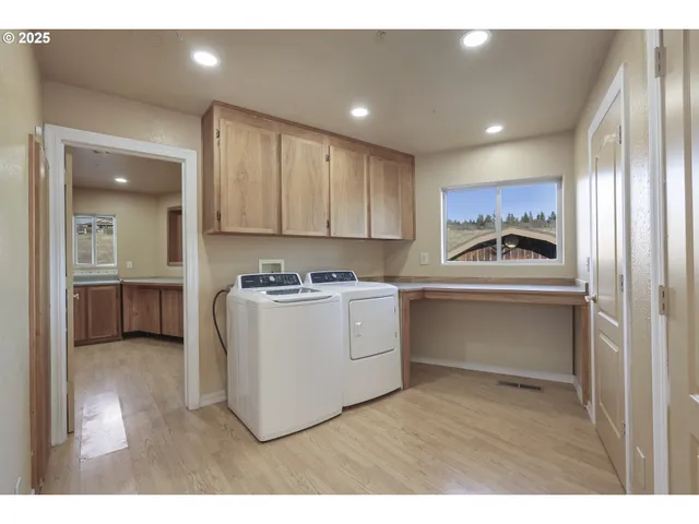 a kitchen with a refrigerator sink and cabinets
