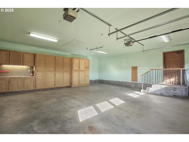 a view of a livingroom with a flesh screen tv and stairs