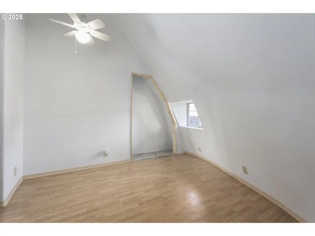 a view of an empty room and a ceiling fan