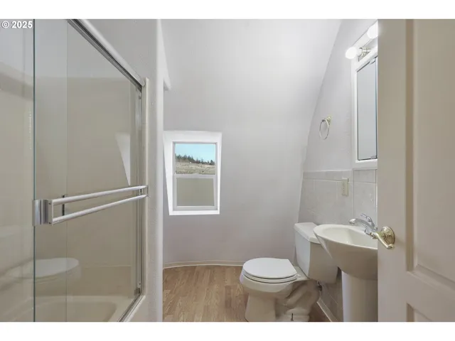 a bathroom with a toilet sink and a mirror