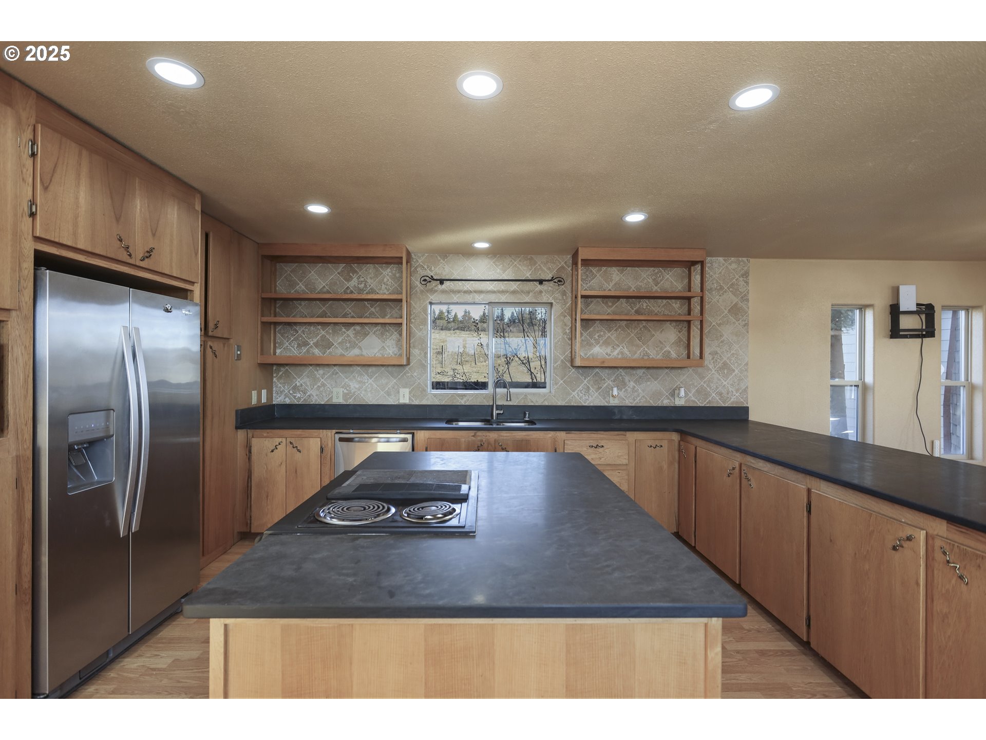 401 Johnson Road Lyle, WA 98635 - Photo 8 of 48 a kitchen with kitchen island a counter top space a sink stainless steel appliances and cabinets