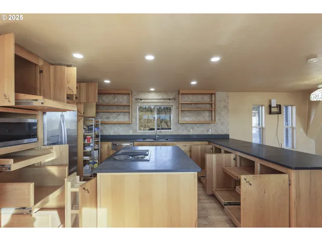 a kitchen with stainless steel appliances granite countertop a sink and cabinets