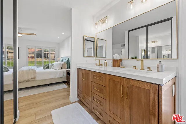 a bathroom with a shower sink and mirror