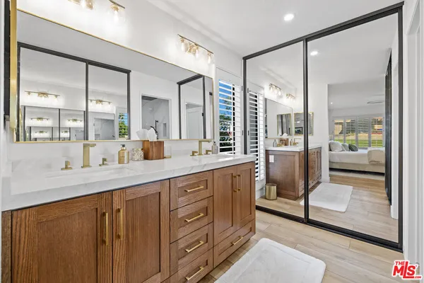 a bathroom with a shower sink and mirror