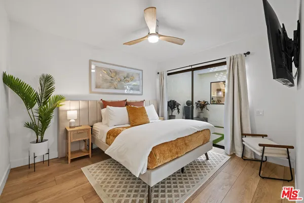 a bedroom with a large bed and a chandelier