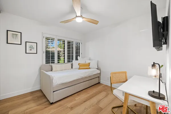 a bedroom with a bed and a flat screen tv